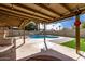 Inviting backyard with a sparkling pool and a covered patio with string lights at 3503 E Campo Bello Dr, Phoenix, AZ 85032