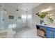 This bathroom features a spacious walk-in shower and a blue vanity with white countertop at 3929 E Flintlock Dr, Queen Creek, AZ 85142