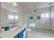 Beautiful bathroom featuring a modern vanity, quartz countertop, and a glass-enclosed shower at 3929 E Flintlock Dr, Queen Creek, AZ 85142