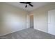 A cozy bedroom features neutral walls, plush carpet, and a ceiling fan for comfortable living at 3929 E Flintlock Dr, Queen Creek, AZ 85142