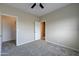 This carpeted bedroom features neutral walls and a ceiling fan, with access to a closet at 3929 E Flintlock Dr, Queen Creek, AZ 85142