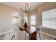 Dining area with neutral walls, a modern light fixture, and adjacent sunlit rooms at 3929 E Flintlock Dr, Queen Creek, AZ 85142