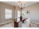 Charming dining area with wood table, chandelier, and bright windows at 3929 E Flintlock Dr, Queen Creek, AZ 85142