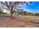 Inviting home with a classic covered porch, complemented by lush landscaping and mature trees at 3929 E Flintlock Dr, Queen Creek, AZ 85142