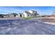 View of the home's exterior, showcasing a large driveway and complementary outbuildings at 3929 E Flintlock Dr, Queen Creek, AZ 85142