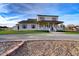 Charming two-story home featuring a welcoming front porch, set against manicured landscaping at 3929 E Flintlock Dr, Queen Creek, AZ 85142