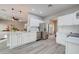 Open concept kitchen with stainless steel appliances and white cabinets at 3929 E Flintlock Dr, Queen Creek, AZ 85142