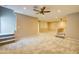 Spacious living room featuring neutral carpet, fan, recessed lighting, and open staircase at 3929 E Flintlock Dr, Queen Creek, AZ 85142