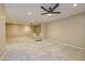 View of the large carpeted living room with neutral walls, ceiling fan, and recessed lighting at 3929 E Flintlock Dr, Queen Creek, AZ 85142