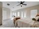 View of this main bedroom which features carpet, a ceiling fan, plenty of windows, and an attached nook at 3929 E Flintlock Dr, Queen Creek, AZ 85142