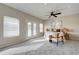 This main bedroom features neutral walls, plush carpet, a ceiling fan, and access to a private patio at 3929 E Flintlock Dr, Queen Creek, AZ 85142