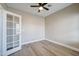 Bright, empty office space featuring a ceiling fan, light-colored walls, and glass paneled door at 3929 E Flintlock Dr, Queen Creek, AZ 85142