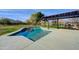 Refreshing pool with shade structure and a serene backdrop, perfect for outdoor relaxation at 3929 E Flintlock Dr, Queen Creek, AZ 85142