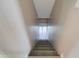 Carpeted staircase with neutral walls leads to a bright lower level at 3929 E Flintlock Dr, Queen Creek, AZ 85142