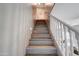 Modern staircase with hardwood steps and white railing at 3929 E Flintlock Dr, Queen Creek, AZ 85142