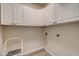 This utility room has plenty of cabinet space and contains hookups for a washer and dryer at 3929 E Flintlock Dr, Queen Creek, AZ 85142