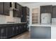 Spacious kitchen with dark cabinetry, quartz countertops, stainless steel range hood, and a walk-in pantry at 3951 E Gold Mountain Ave, San Tan Valley, AZ 85143