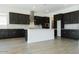 Modern kitchen with dark wood cabinets, stainless steel appliances, white countertops, and wood-look tile flooring at 3951 E Gold Mountain Ave, San Tan Valley, AZ 85143