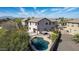 Aerial view of a home with a pool, hot tub, and pergola in a well-maintained backyard at 4019 W Valley View Dr, Laveen, AZ 85339