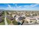 Overhead view of a neighborhood with houses, pools, and green spaces under a blue sky at 4019 W Valley View Dr, Laveen, AZ 85339