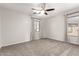 Bedroom with ceiling fan, carpet flooring, window with curtains and neutral colored walls at 4019 W Valley View Dr, Laveen, AZ 85339