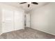 This neutral bedroom features a ceiling fan and a closet with sliding doors at 4019 W Valley View Dr, Laveen, AZ 85339