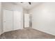 Neutral bedroom with sliding door closet and views into the hallway at 4019 W Valley View Dr, Laveen, AZ 85339