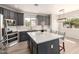 Bright kitchen with gray cabinets, stainless steel appliances, and a large center island with a white countertop at 4019 W Valley View Dr, Laveen, AZ 85339