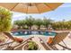 Inviting backyard pool with lounge chairs and an umbrella for relaxation at 4019 W Valley View Dr, Laveen, AZ 85339