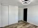 Bedroom featuring wood-look flooring, a ceiling fan, and a closet, creating a comfortable living space at 4065 E University Dr # 407, Mesa, AZ 85205