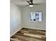 This bedroom features wood-look flooring, fresh paint, and a new ceiling fan at 4065 E University Dr # 407, Mesa, AZ 85205