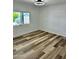 Bedroom featuring wood-look flooring, and a window, creating a comfortable and stylish living space at 4065 E University Dr # 407, Mesa, AZ 85205