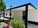 Exterior entrance with black framed windows and shade covering the porch at 4065 E University Dr # 407, Mesa, AZ 85205