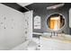 Stylish bathroom featuring black wallpaper, white tiles and a modern faucet at 4222 E Brown Rd # 18, Mesa, AZ 85205