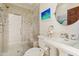 Bathroom highlighting a walk-in shower, patterned tile, a pedestal sink, and a round mirror at 4222 E Brown Rd # 18, Mesa, AZ 85205