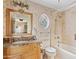 Traditional bathroom showcasing a vanity with a marble countertop, a stained-glass window, and a bathtub at 4222 E Brown Rd # 18, Mesa, AZ 85205