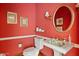 Charming powder room featuring red walls, ornate fixtures, and a unique decorative sink at 4222 E Brown Rd # 18, Mesa, AZ 85205