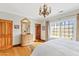 Light-filled bedroom with hardwood floors and a chandelier at 4222 E Brown Rd # 18, Mesa, AZ 85205