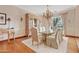 Traditional dining room with a glass table, decorative china cabinet, and hardwood floors for formal gatherings at 4222 E Brown Rd # 18, Mesa, AZ 85205