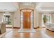 Elegant foyer boasting a grand front door, chandelier, and hardwood floors, creating a welcoming ambiance at 4222 E Brown Rd # 18, Mesa, AZ 85205