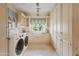 Laundry room with built-in cabinets, custom tile backsplash, and natural light at 4222 E Brown Rd # 18, Mesa, AZ 85205