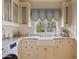 Bright laundry room with custom cabinets, white farmhouse sink, stainless steel appliances, and granite countertops at 4222 E Brown Rd # 18, Mesa, AZ 85205