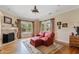 Cozy living room with a fireplace, hardwood floors, and a red love seat and ottoman at 4222 E Brown Rd # 18, Mesa, AZ 85205