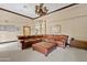 Spacious living room featuring leather furniture, light colored walls, neutral carpeting, and natural light at 4222 E Brown Rd # 18, Mesa, AZ 85205