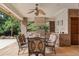 Covered outdoor kitchen features brick accents, stainless steel appliances, and a dining area for entertaining at 4222 E Brown Rd # 18, Mesa, AZ 85205