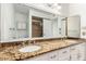 Well-lit bathroom features dual sinks, granite counters, a large mirror, and white cabinetry at 4323 W Villa Theresa Dr, Glendale, AZ 85308