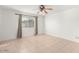 Bedroom featuring tile flooring, a window with curtains, and a ceiling fan at 4323 W Villa Theresa Dr, Glendale, AZ 85308