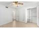 Bright bedroom featuring tile flooring, a ceiling fan, and a closet with ample storage space at 4323 W Villa Theresa Dr, Glendale, AZ 85308