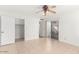 Bright bedroom featuring tile flooring, a ceiling fan, and access to a closet and outdoor space at 4323 W Villa Theresa Dr, Glendale, AZ 85308