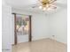 Cozy bedroom with tile flooring, a ceiling fan, and a window with views of the neighborhood at 4323 W Villa Theresa Dr, Glendale, AZ 85308